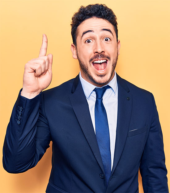 Young hispanic man wearing suit pointing finger up with successful idea. exited and happy. number one.